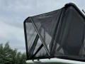 Rain-Shade-installed-on-a-James-Baroud-Nova-rooftop-tent-outdoor-side-view.webp